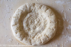 Tandyr nan Uzbek bread, a type of Central Asian bread, often decorated by  stamping patterns on the dough by using a bread stamp known as a chekich,  al Stock Photo - Alamy