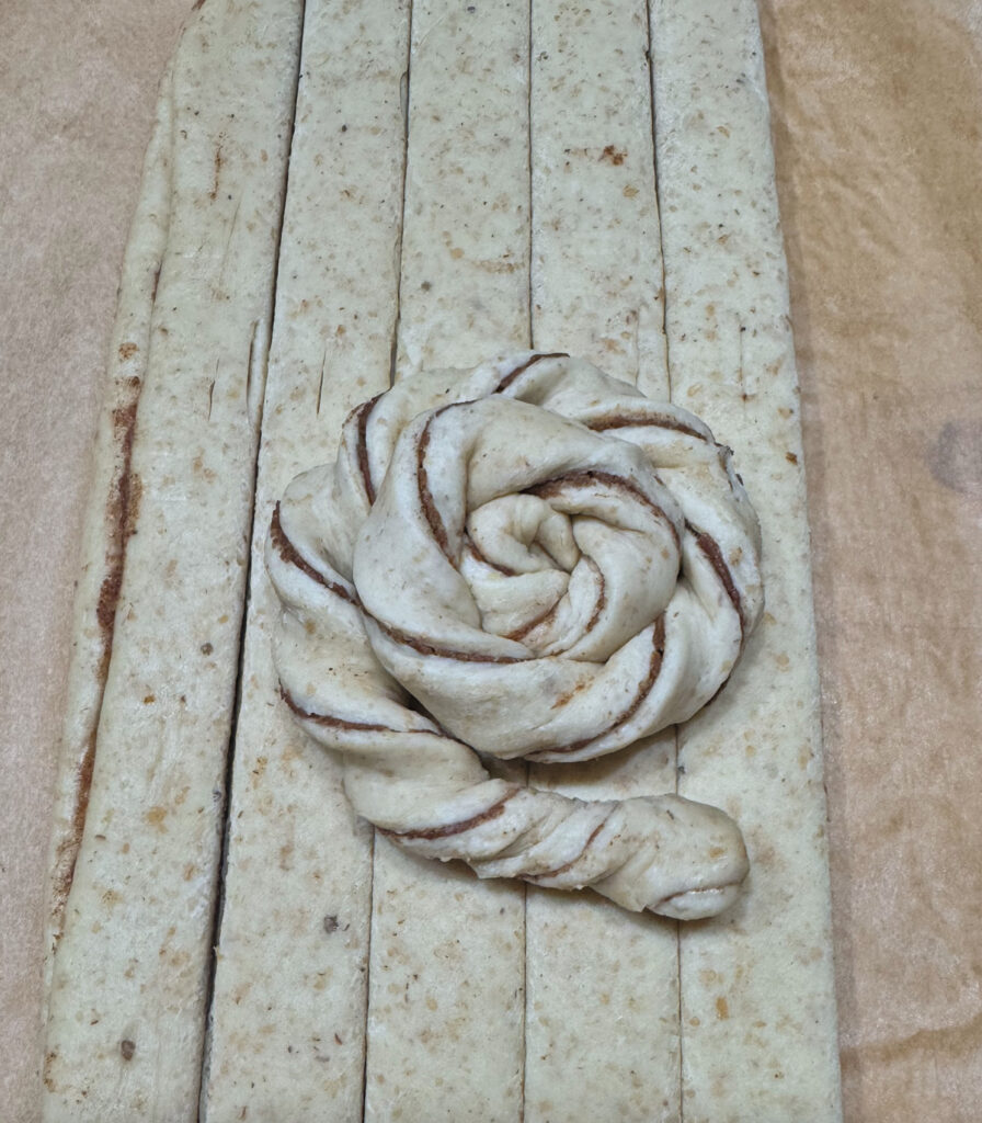 A finished coil with the cinnamon swirl spiraling out from the center and the end tucked under.