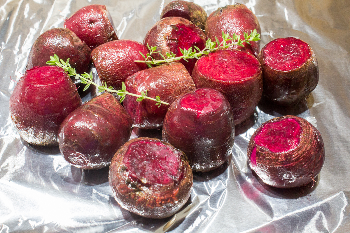 red beets ready to be roasted with sprigs of thyme