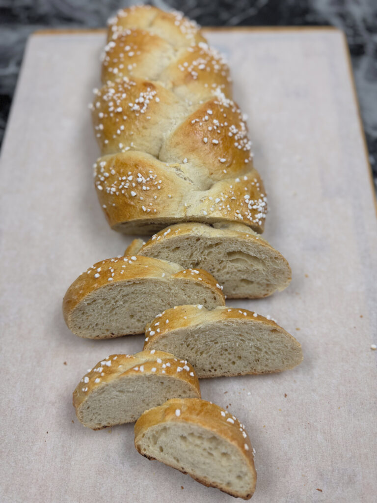 Sourdough Finnish Pulla Braid sliced and resting on parchment