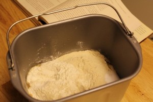 adding ingredients to bread maker pan