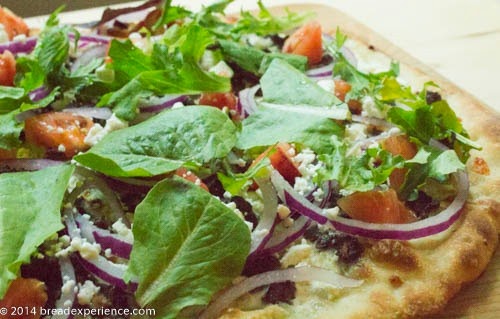 Governator Burger Pizza with salad greens