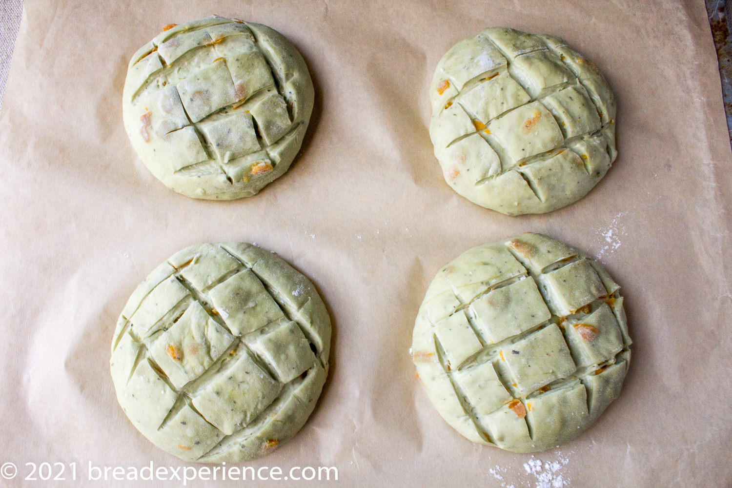 Loaves scored on parchment