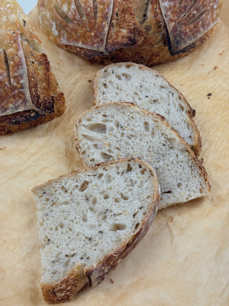 Sliced Orange Zest Sourdough Boule on Parchment
