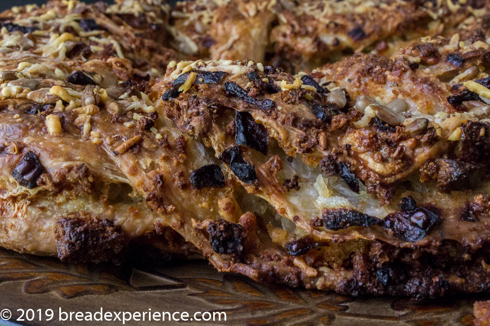 Sourdough Savory Danish Bread Crown with closeup of flaky layers