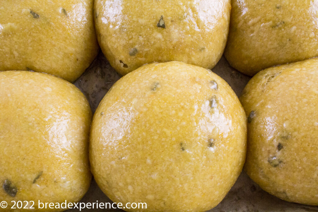 close up shot of melted butter brushed on sourdough tangzhong rolls