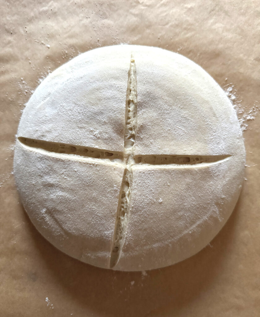 Scored Basic Sourdough Loaf on parchment 