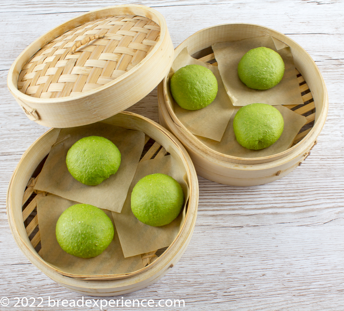 spinach buns in bamboo steamer before steaming