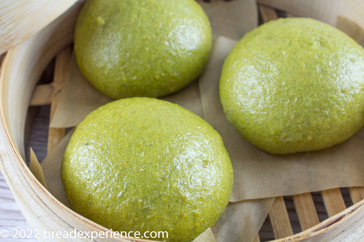 spinach buns in bamboo steamer
