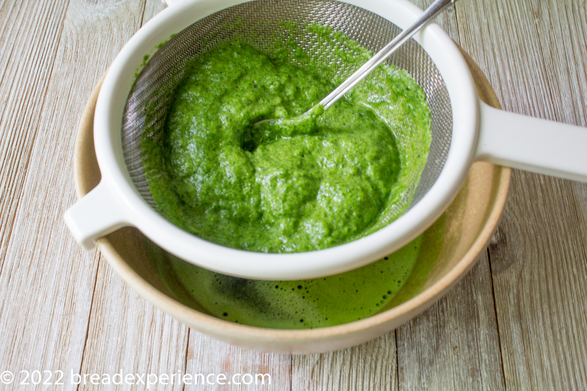 straining spinach puree 