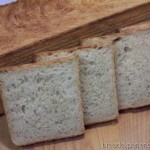 Sliced Toast Bread with Teff on a wooden board, showing a fine, even crumb.