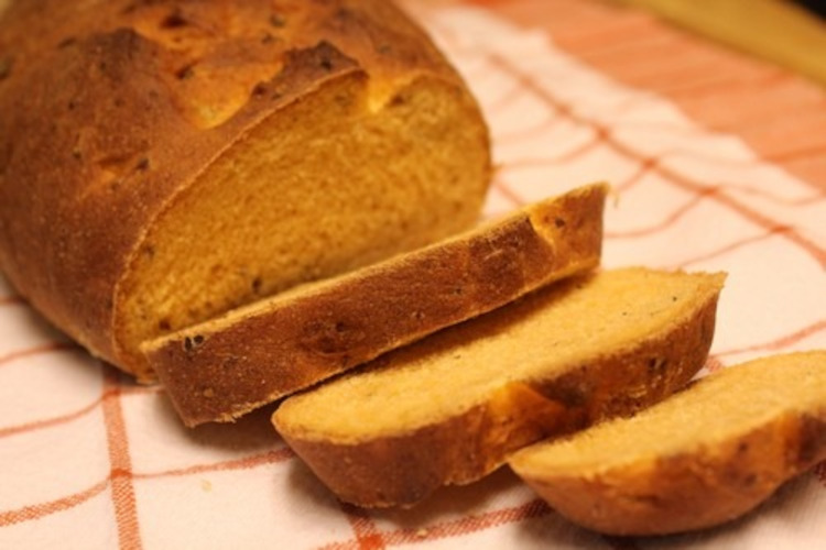 Crumb shot of Tomato Basil Loaf on an orange towel