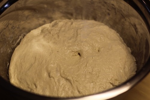 Dough after bulk fermentation, showing increased volume and a smoother, more relaxed surface.